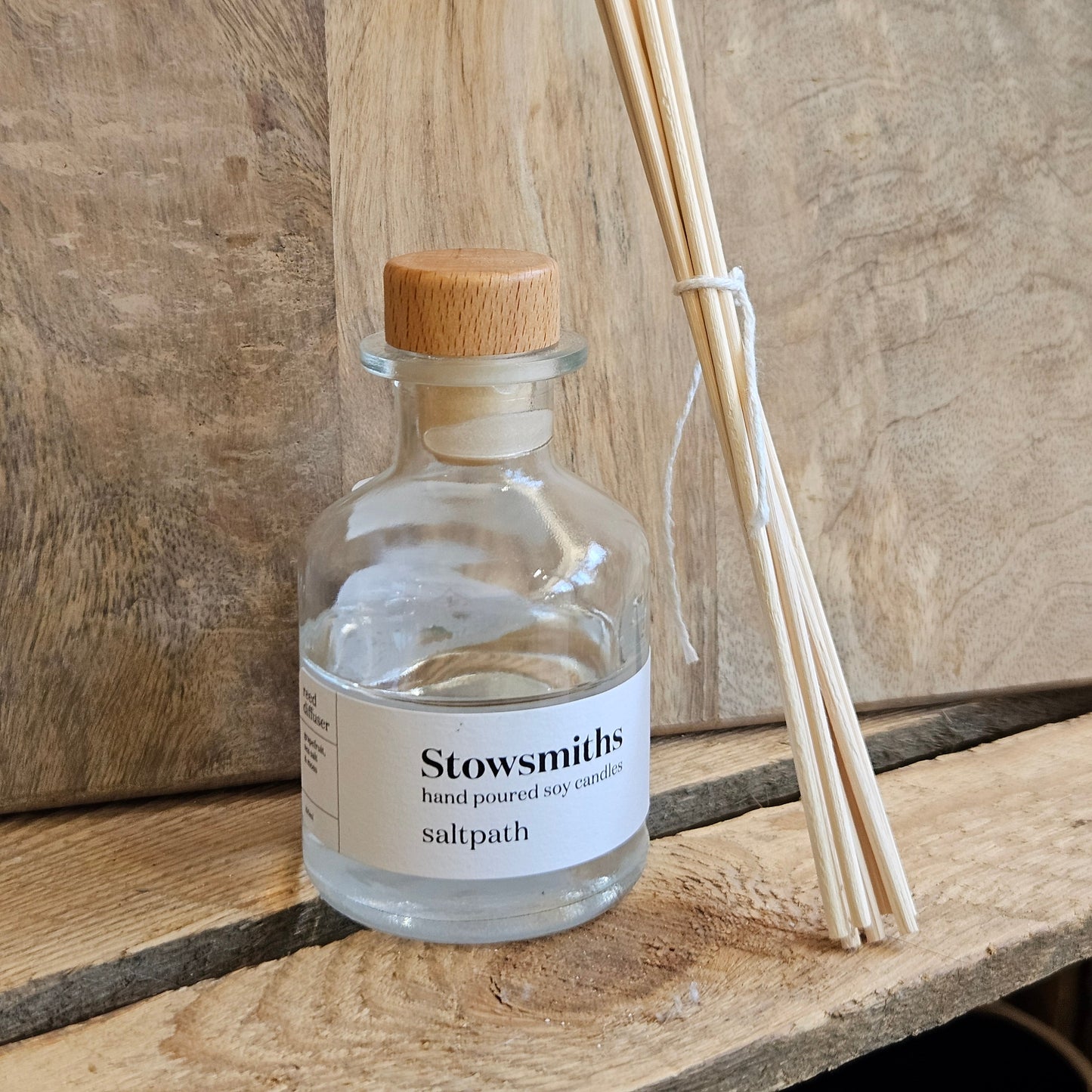 a clear glass reed diffuser bottle poured in the Cotswolds